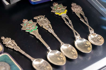 Aldershot, UK - 5th September 2020: A row of silver and brass ceremonial military spoons on display in army museumのeditorial素材