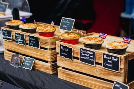 Pies and food being sold at a market in the UK with British English flagsの写真素材