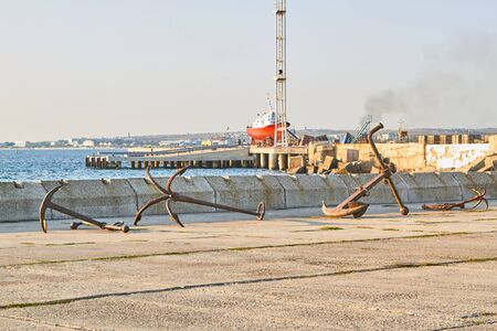 Different types of old rusty anchors in the seaportの写真素材