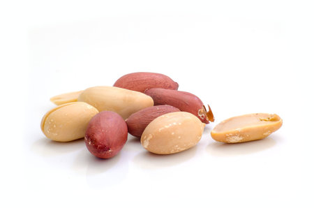 The Dried peanuts on the white background.