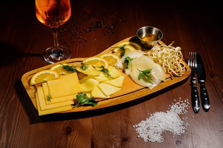Assorted different types of cheese on a wooden board.Assortment of different cheese types on wooden...