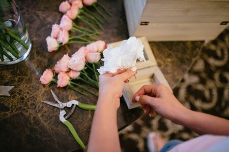 Florist's table with flowers. Florist makes flowers on the photoの写真素材