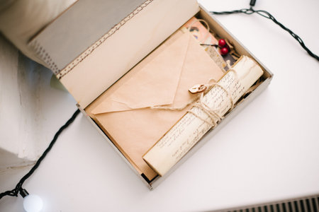 A cardboard box with a gift is on the table. A gift is on the table.