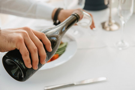 Man pours champagne into a glass