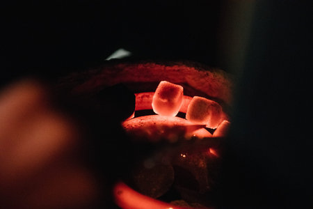 Man changes the coals in the hookah