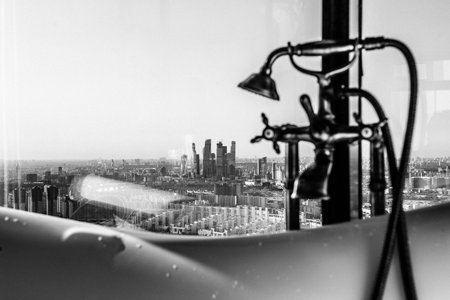 Freestanding White bathroom with city views in the house close up