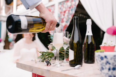 Man pours champagne into a glass