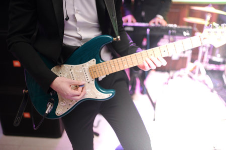 Man playing guitar indoors close up.Musician playing guitar close up
