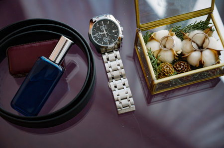 Men's perfume and wrist watches in a box close-up.