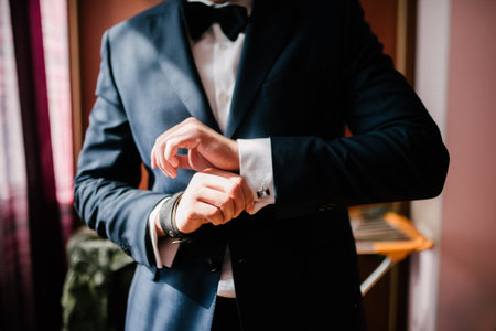 Man in suit straightens shirt sleeve close up