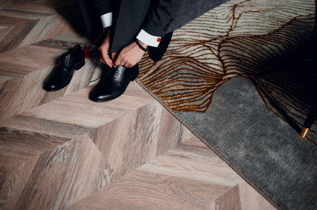 A man in a suit puts shoes
