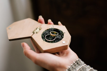 wedding rings are in a wooden box