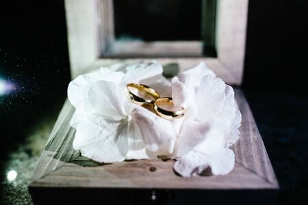 wedding rings are in a wooden boxの写真素材