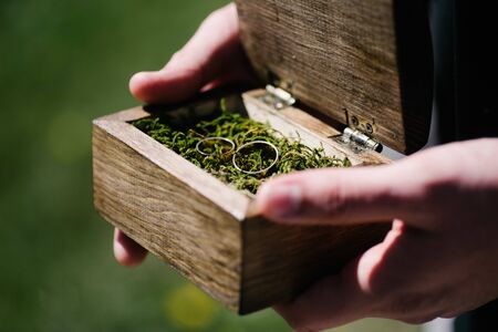 wedding rings are in a wooden boxの写真素材