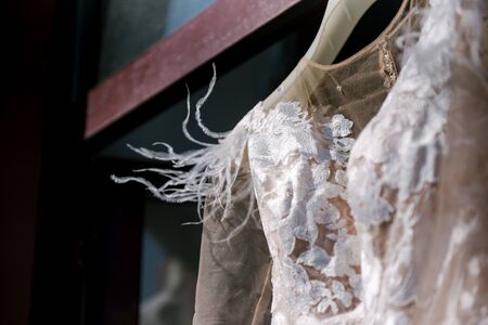 White wedding dress hanging in the bedroom. White bride dress close upの写真素材