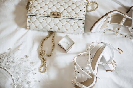 Women's accessories bride. Handbag, shoes, rings, bridal perfume close upの写真素材