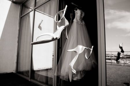 White wedding dress hanging in the bedroom. White bride dress close upの写真素材