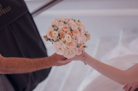 Bride in a wedding dress holding a wedding bouquet in her hands