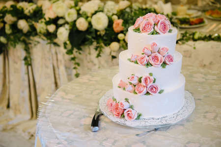 Big white wedding cake with fruit is on the table close upの写真素材