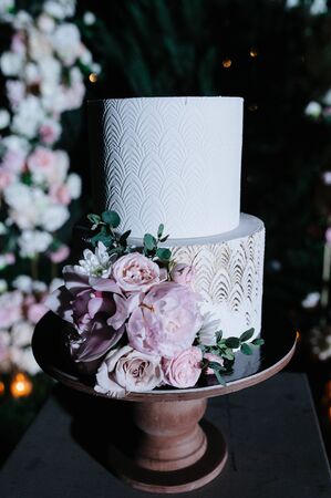 Big white wedding cake with fruit is on the table close upの写真素材