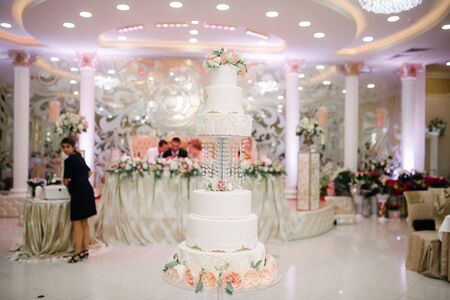 Big white wedding cake with fruit is on the table close upの写真素材