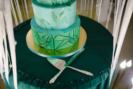 Large green wedding cake close-up on the wedding table close up