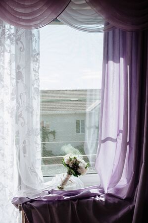 White bouquet of flowers standing in a vase on the window lose upの写真素材