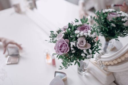 a bouquet of purple flowers lies on a chair close-upの写真素材