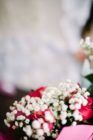 a bouquet of purple flowers lies on a chair close-upの写真素材