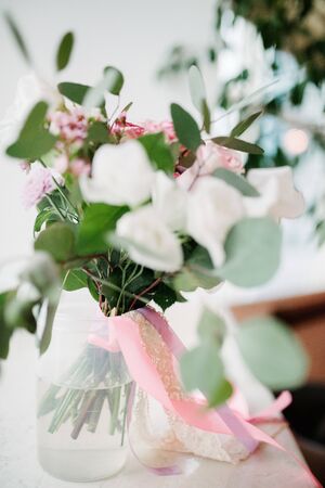 White bouquet of flowers standing in a vase on the window lose upの写真素材