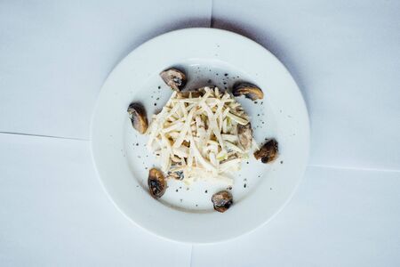 Mussels salad with sauce on a white plateの写真素材
