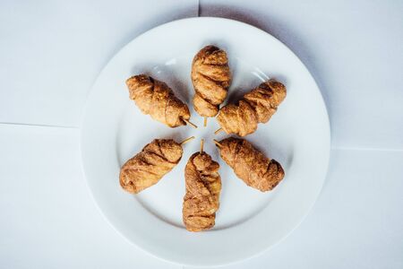 Triangular toast sandwiches with lettuce and ham on a plateの写真素材