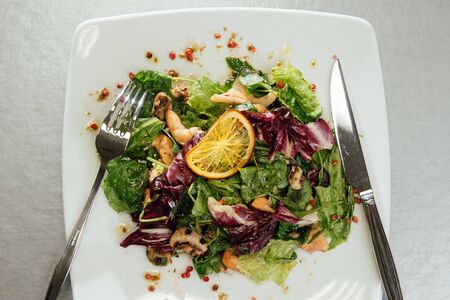 Salad with shrimps and greens on a plate on the tableの写真素材