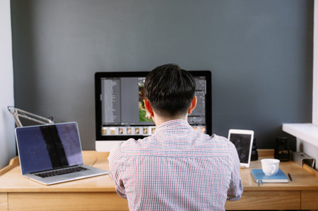 Professional Photographer Works in Photo Editing App. Software on His Personal Computer.Photographer...