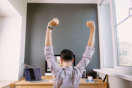 Professional photographer resting at workplace in office. Photographer for processing photos. Photographer equipment on the table.の写真素材