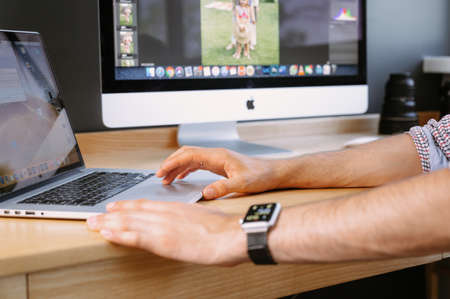 Professional Photographer Works in Photo Editing App. Photographer processes photos on a laptop.Photographer for processing photos. Photographer equipment on the table. Retouching photos.のeditorial素材