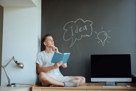Young smiling man has an idea.Idea concept.Portrait young man has an idea, pointing with finger up...