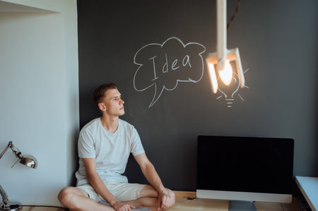 Young smiling man has an idea.Idea concept.Portrait young man has an idea, pointing with finger up...