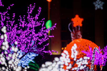 Bright Christmas decorations on urban trees. Decoration of the city.Blurred bokeh basic background for designの写真素材