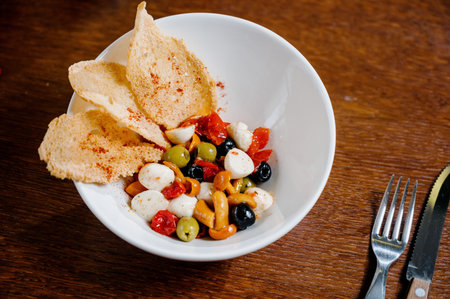 appetizer with pickled mushrooms, olives, parmesan on wooden background