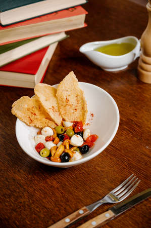 appetizer with pickled mushrooms, olives, parmesan on wooden backgroundの写真素材