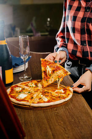 pizza with chicken, mozzarella, olives and basil top view with copy space.Pizza with chicken and pickles on a wooden backgroundの写真素材