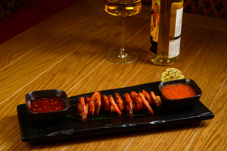 Delicious roasted shrimps on skewers with sauce and lemon. Top view with copy space. Flat layの写真素材