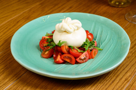 Stuffed dumpling with tomatoes.Traditional manti food on plate on wooden background
