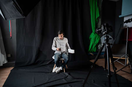 Happy female blogger making video review of new mobile phone, opening box with modern device, filming content for his vlog indoors.の写真素材