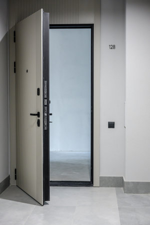 Bright interior of a modern apartment featuring large glass windows and a wooden floor, with a...