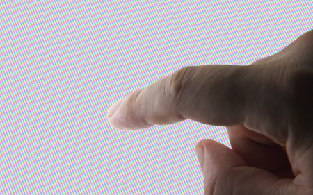 Human finger on white screen.の写真素材