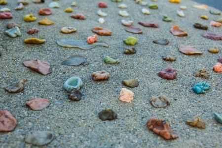 Multicolored gum stuck to cement の写真素材