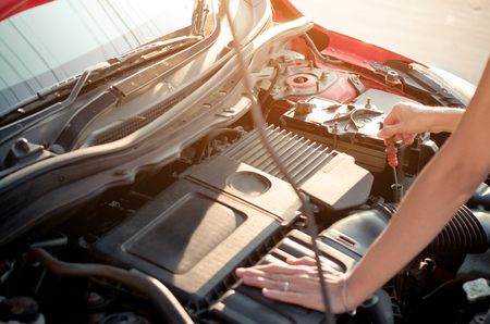 Asian woman's hand checking engine oil car engineの写真素材
