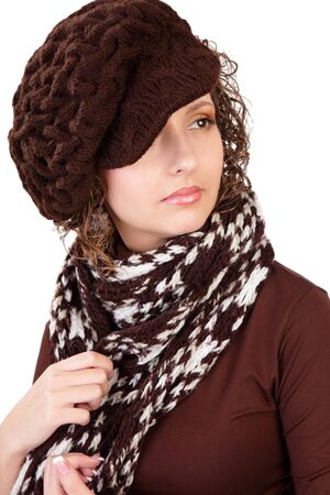 Portrait of the beautiful young girl in a winter cap and with a scarf isolated on a white backgroundの写真素材